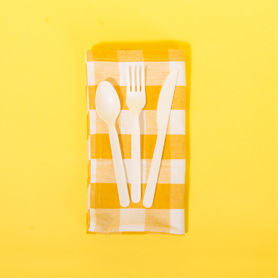 Repurpose Picnic with a Purpose featuring our Repurpose Compostable Assorted Cutlery on a yellow plaid napkin