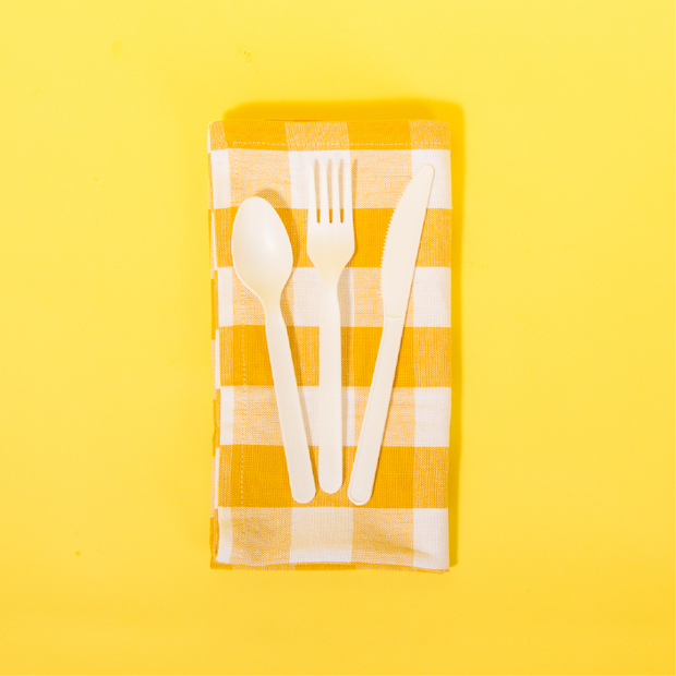 Repurpose Picnic with a Purpose featuring our Repurpose Compostable Assorted Cutlery on a yellow plaid napkin
